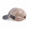 Rear view of gray and tan mesh trucker cap with adjustable snapback and navy patch reading ‘Be Legendary’